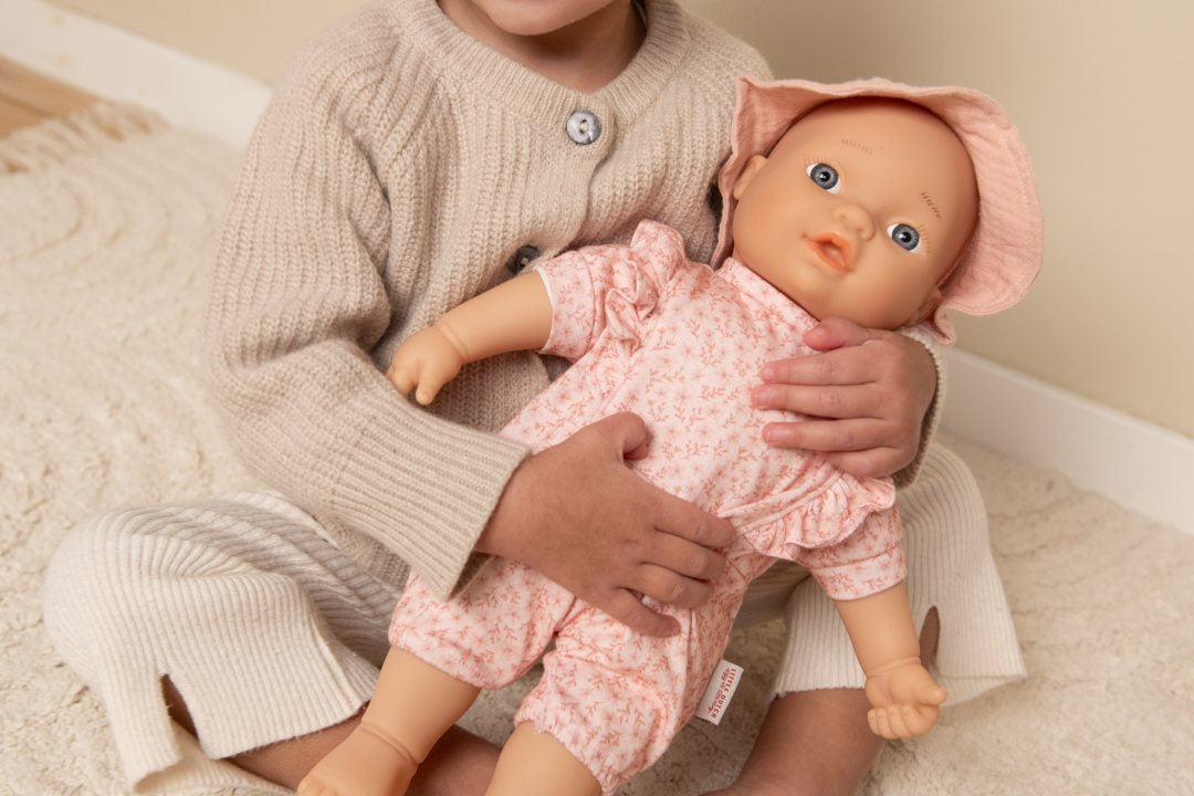 Detailansicht des rosa Puppen-Outfits mit floralen Details
